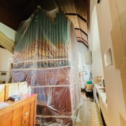 Our church organ all wrapped up to protect it from dust.